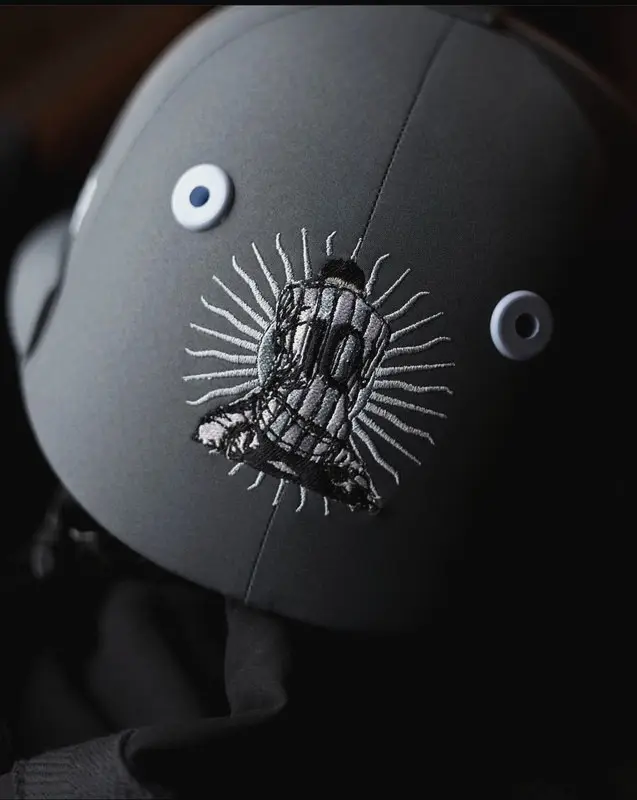 Close-up of a crest embroidered on a helmet cover