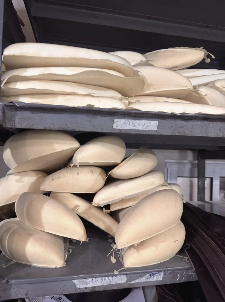 Moulded EPP helmet liners stacked on metal shelving